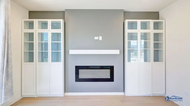 a living room with a fireplace and windows