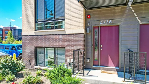 a front view of a house with plants