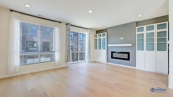 a view of an empty room with a fireplace and a window
