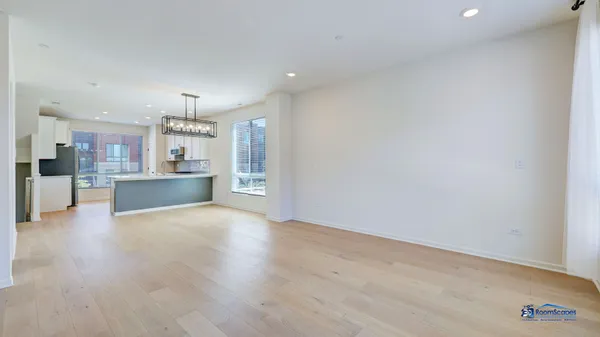 a view of a kitchen with a sink and a refrigerator
