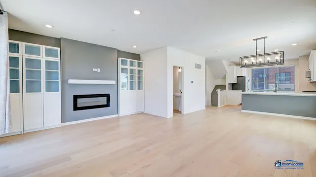 a view of a livingroom with a fireplace and window
