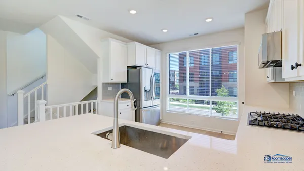 a kitchen with a refrigerator a sink and a stove