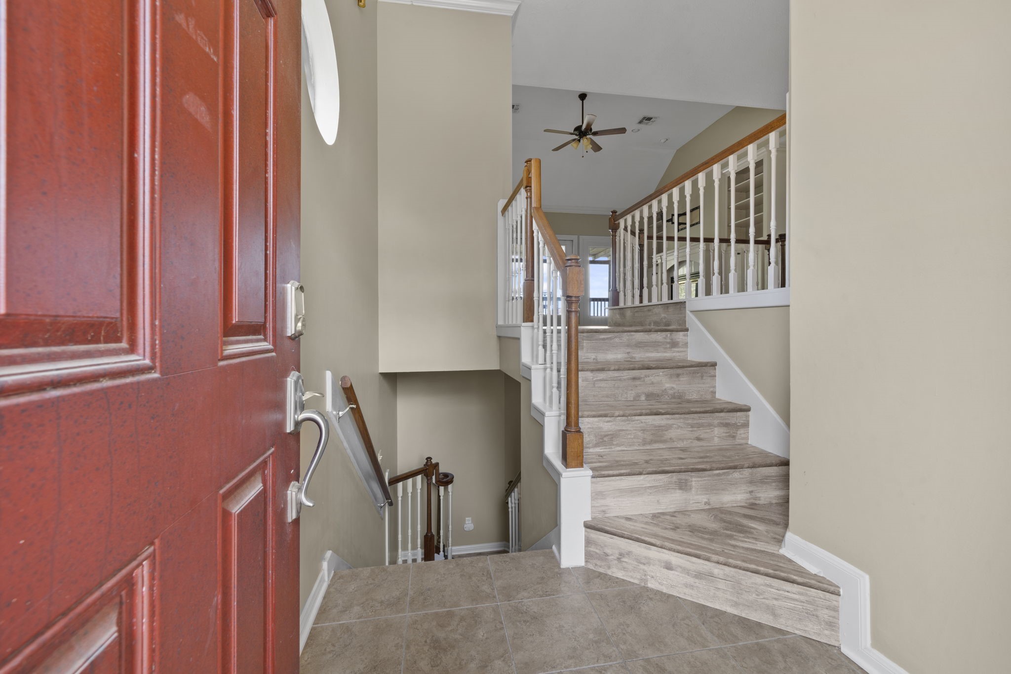 169 April Cove Montgomery, TX 77356 - Photo 5 of 39 You'll be instantly greeted by beautiful tile floors and a charming stair case.