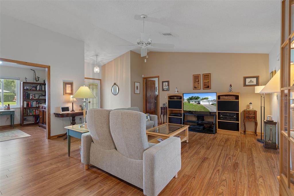 5035 Harbinger Road Spring Hill, FL 34608 - Photo 17 of 47 a living room with furniture and a wooden floor