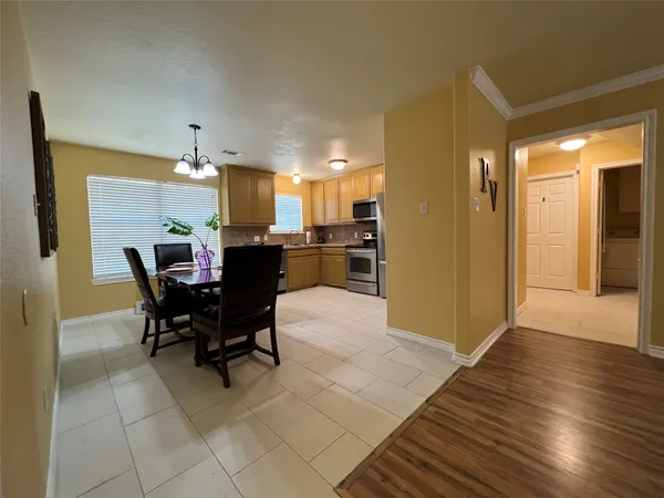a dining room with furniture and wooden floor