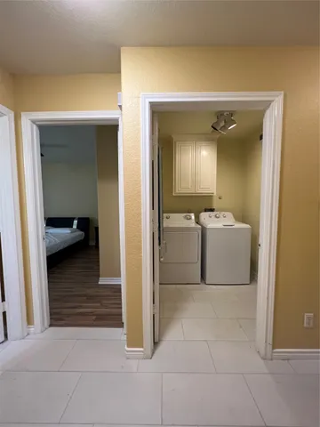 a spacious bedroom with a bed and wooden floor