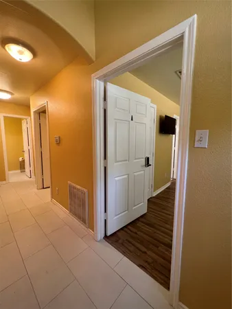 a view of a hallway with wooden floor