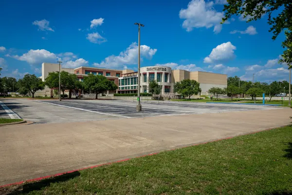 a front view of a building and trees