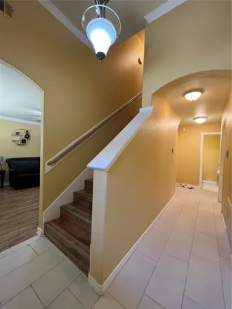 a view of entryway and hall with wooden floor