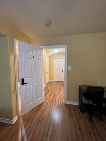 a room with wooden floor and furniture