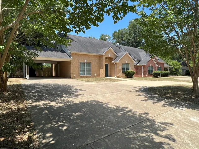 a kitchen with stainless steel appliances granite countertop a stove top oven a sink dishwasher and a refrigerator