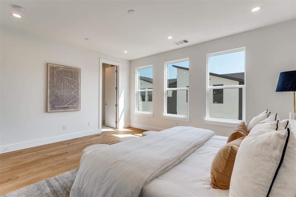 3940 Spring Valley Road, Unit 1 Farmers Branch, TX 75244 - Photo 13 of 19 a bedroom with a large bed and a window
