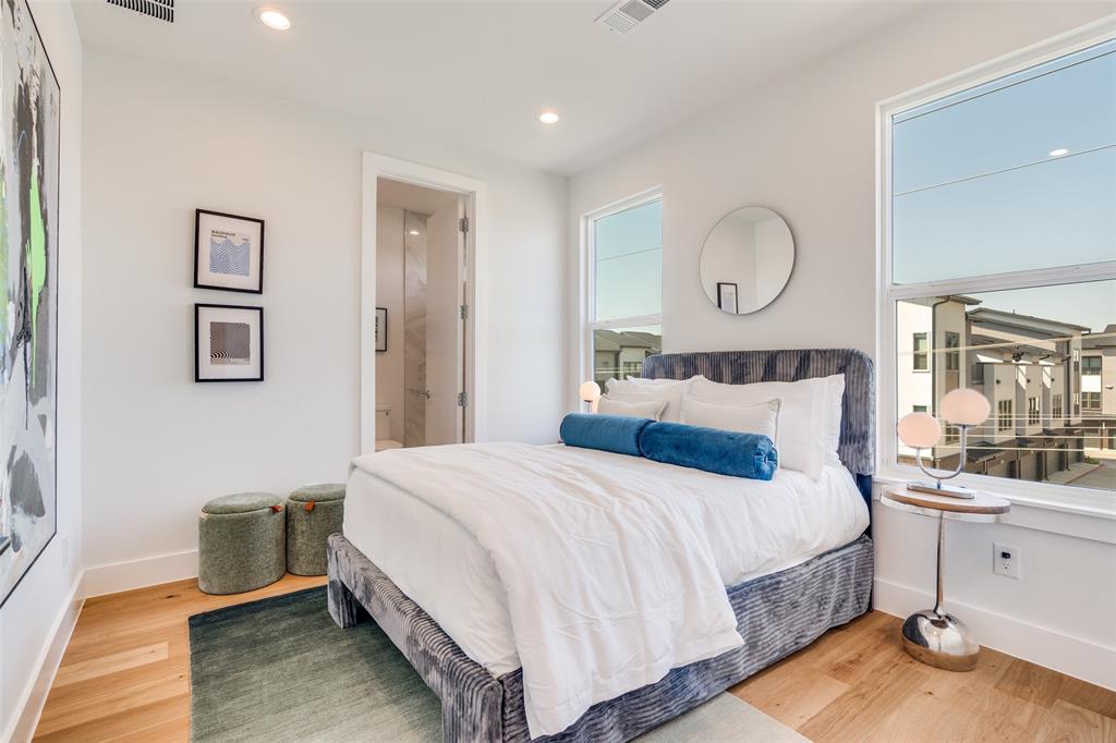 3940 Spring Valley Road, Unit 1 Farmers Branch, TX 75244 - Photo 15 of 19 a bedroom with bed and wooden floor
