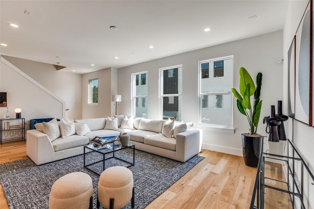 3940 Spring Valley Road, Unit 1 Farmers Branch, TX 75244 - Photo 6 of 19 a living room with furniture a wooden floor and a large window