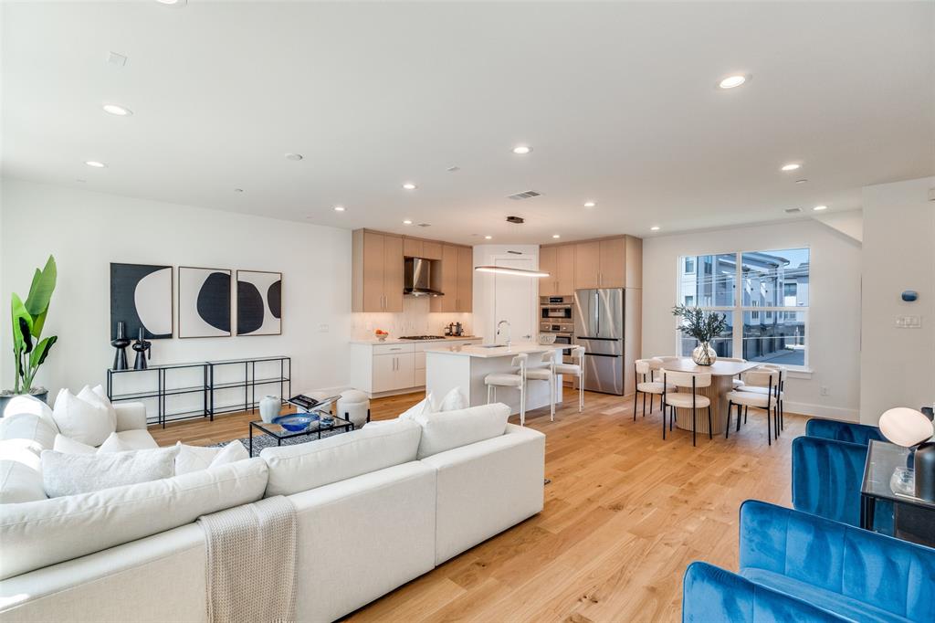 3940 Spring Valley Road, Unit 1 Farmers Branch, TX 75244 - Photo 8 of 19 a living room with furniture and a wooden floor