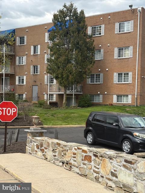 300 Byberry Road, Unit 202 Philadelphia, PA 19116 - Photo 4 of 32 a car parked in front of a brick house