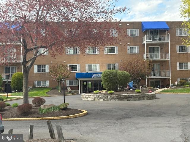 300 Byberry Road, Unit 202 Philadelphia, PA 19116 - Photo 5 of 32 a front view of a building with street and trees