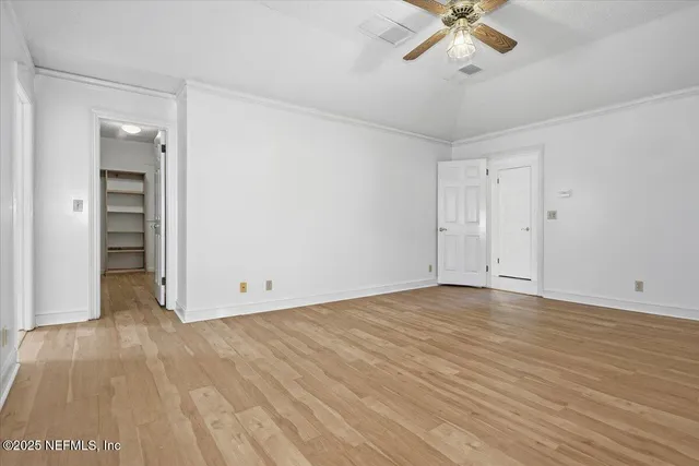 a view of an empty room and wooden floor