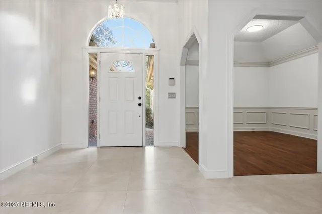 an empty room with wooden floor and cabinet