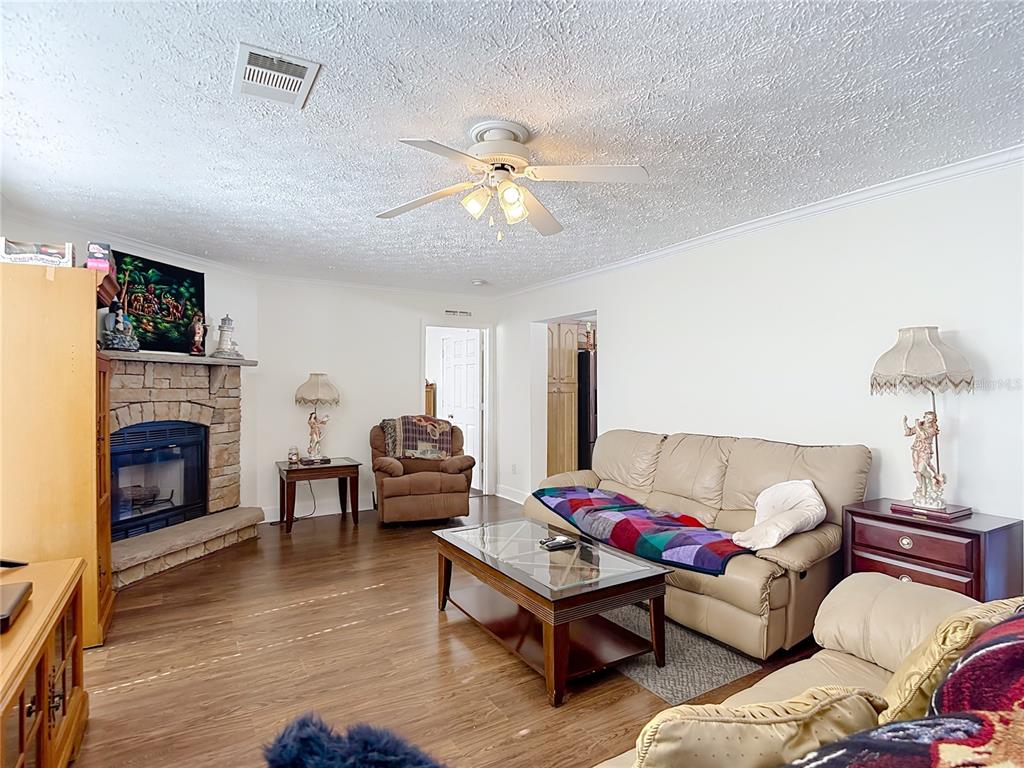 15821 Archer Street Hudson, FL 34667 - Photo 19 of 77 a living room with furniture and a fireplace