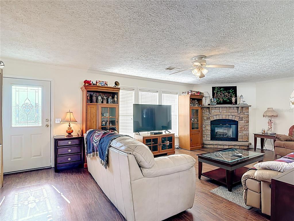 15821 Archer Street Hudson, FL 34667 - Photo 21 of 77 a living room with furniture and a fireplace