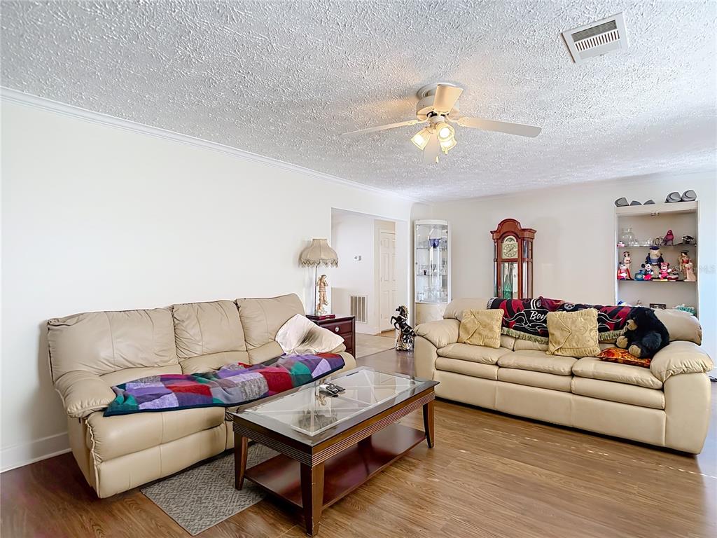15821 Archer Street Hudson, FL 34667 - Photo 23 of 77 a living room with furniture and a chandelier