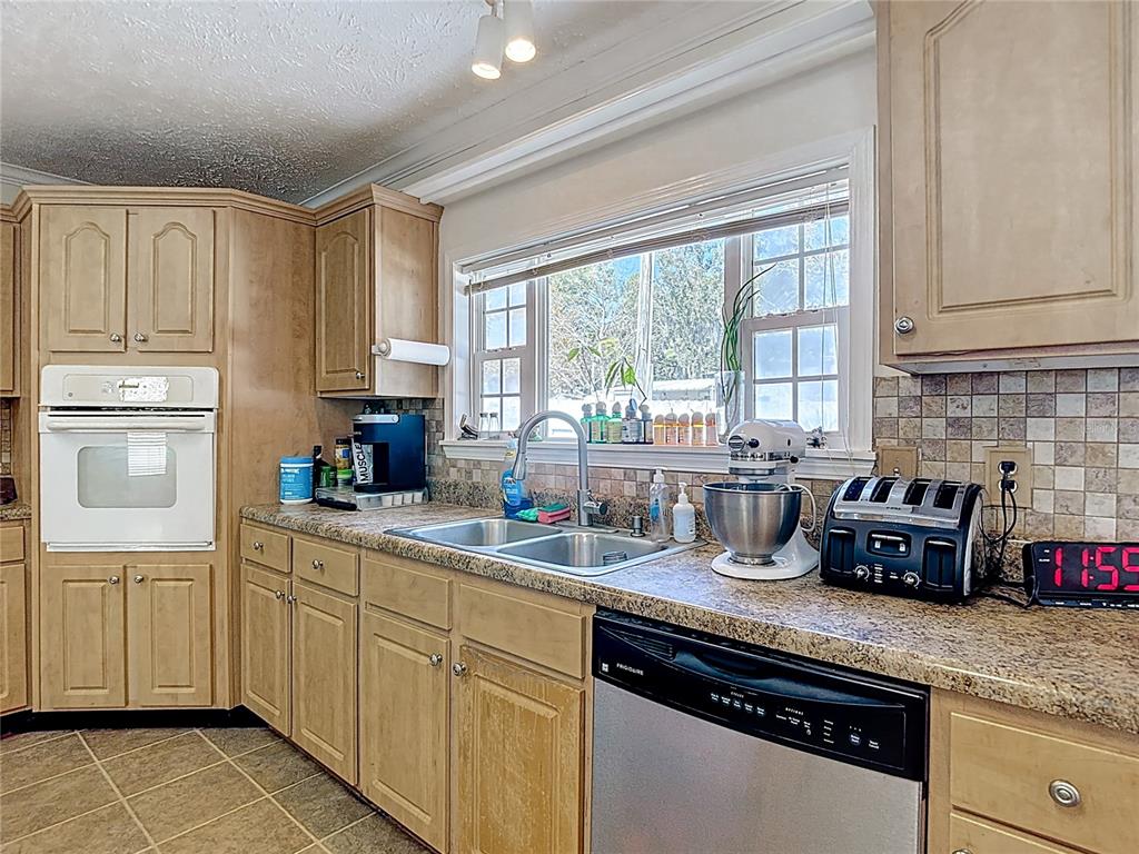 15821 Archer Street Hudson, FL 34667 - Photo 30 of 77 a kitchen with granite countertop a sink stainless steel appliances and cabinets