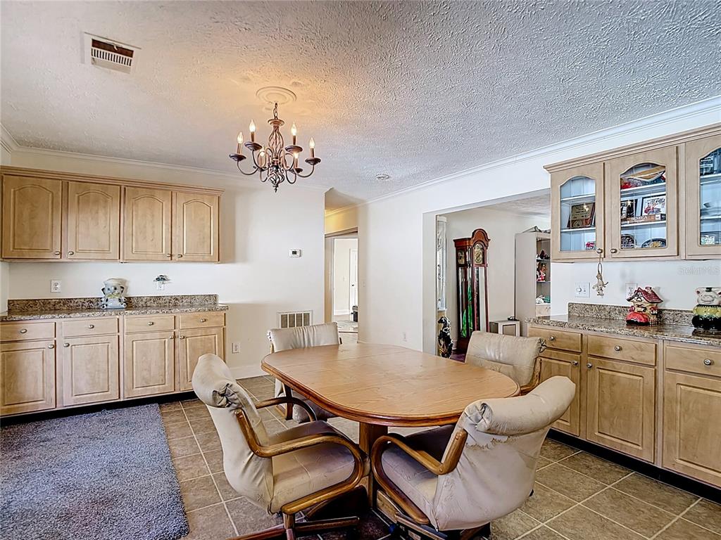 15821 Archer Street Hudson, FL 34667 - Photo 32 of 77 a kitchen with a dining table chairs and view kitchen