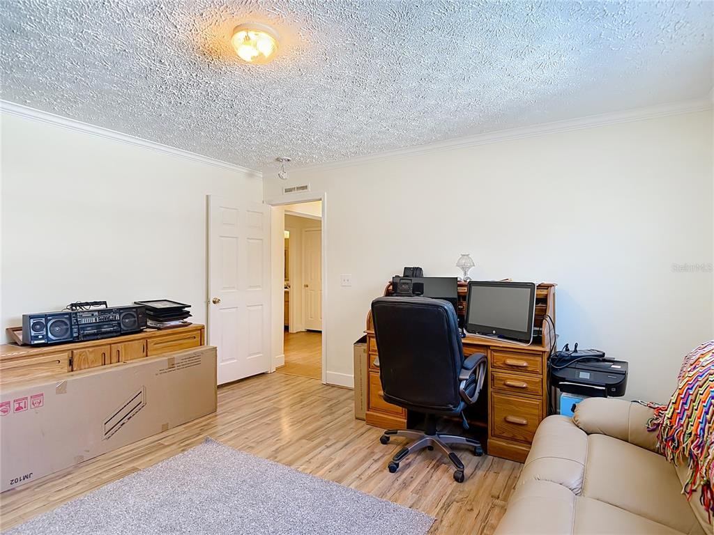 15821 Archer Street Hudson, FL 34667 - Photo 40 of 77 a view of a workspace with furniture and wooden floor
