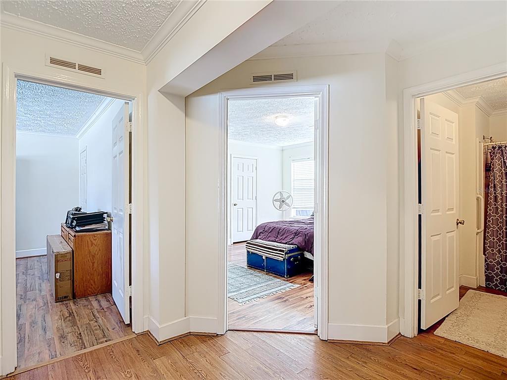 15821 Archer Street Hudson, FL 34667 - Photo 47 of 77 a view of a bedroom from a hallway