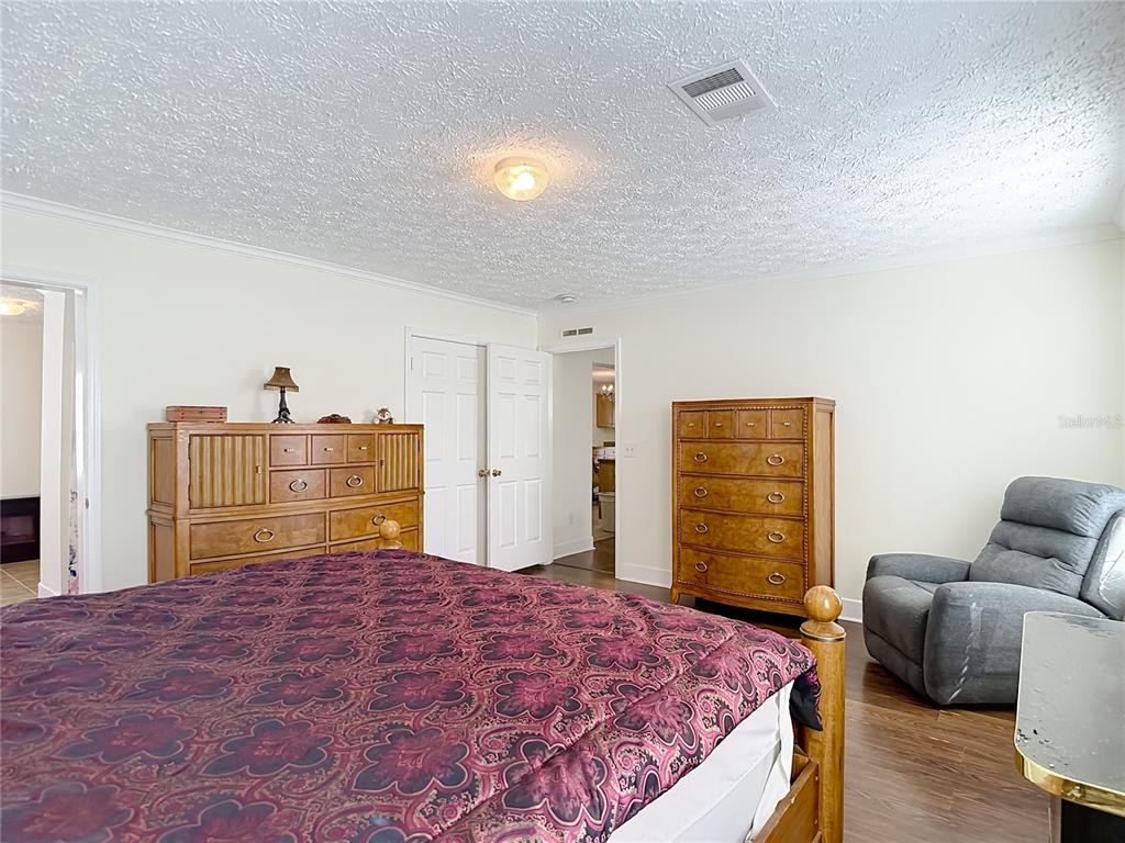 15821 Archer Street Hudson, FL 34667 - Photo 51 of 77 a bedroom with a bed and dresser