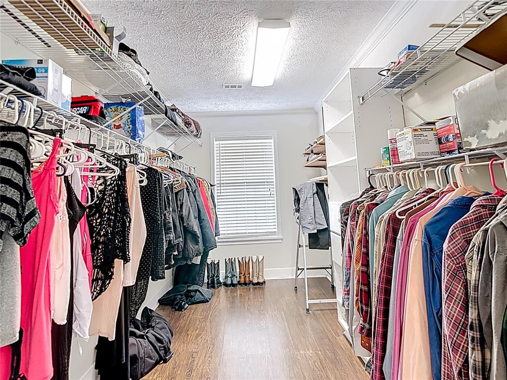 15821 Archer Street Hudson, FL 34667 - Photo 56 of 77 a view of walk in closet with clothes and shoes