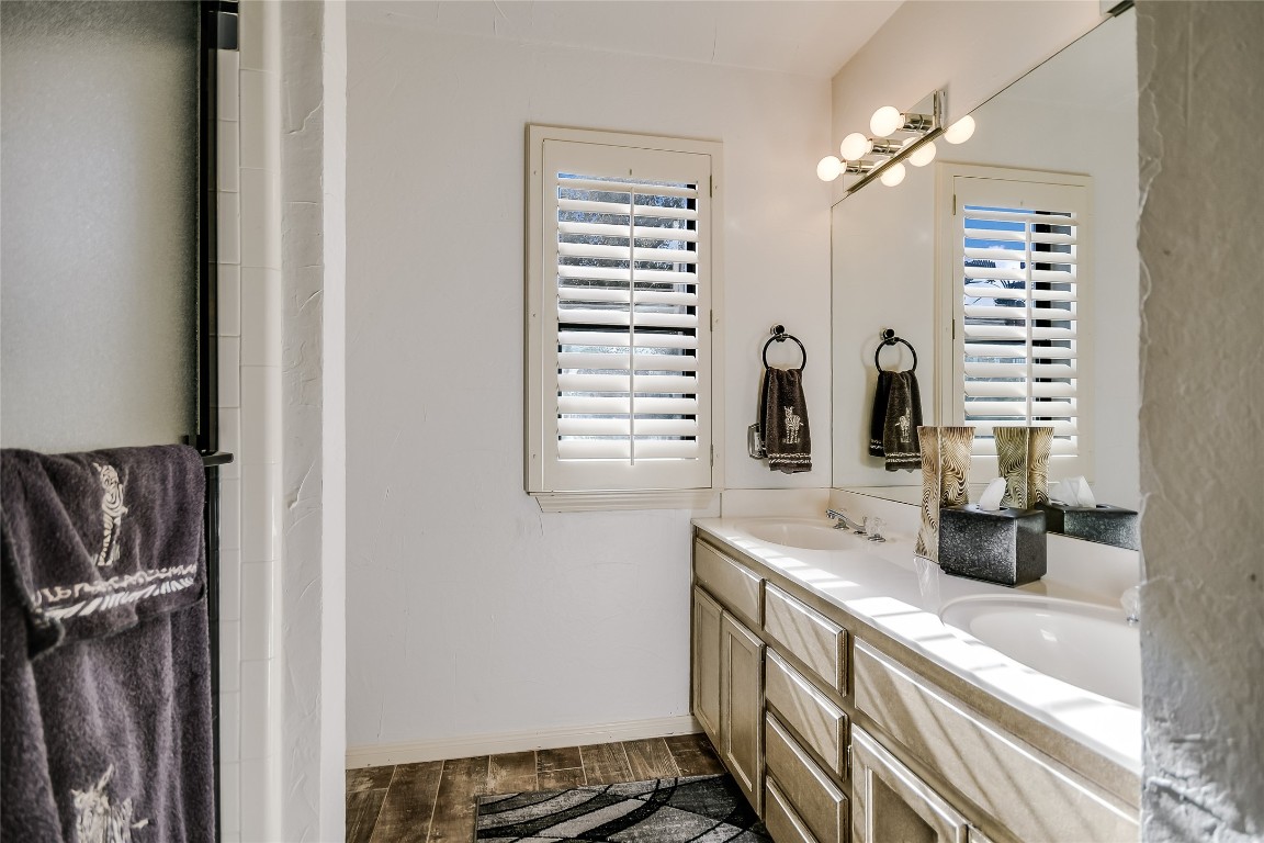 333 Quail Run Court Spicewood, TX 78669 - Photo 19 of 37 a bathroom with a sink and a mirror