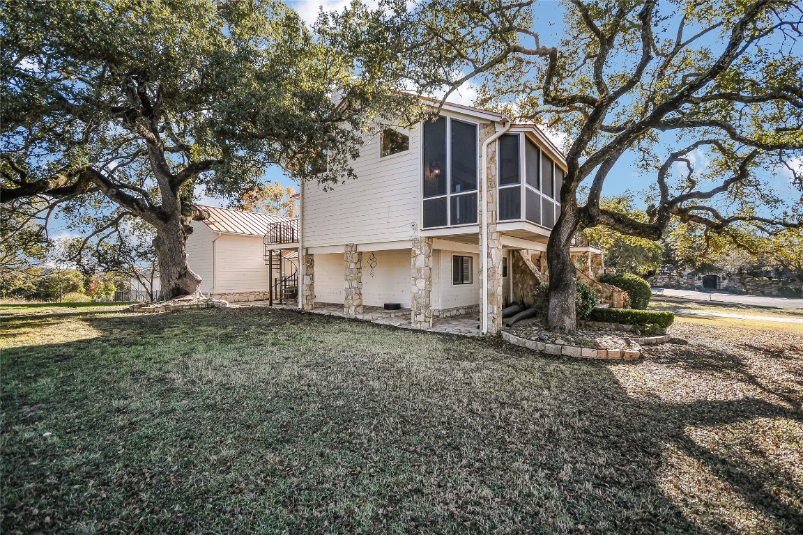 333 Quail Run Court Spicewood, TX 78669 - Photo 7 of 37 a view of a house with a yard