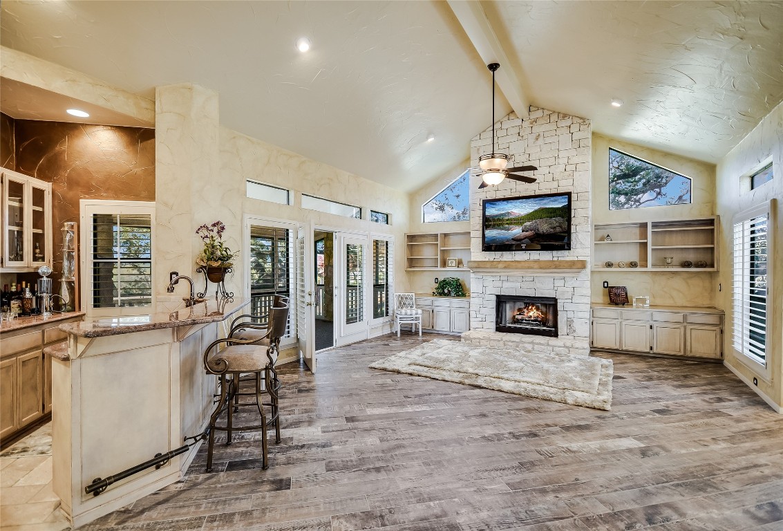 333 Quail Run Court Spicewood, TX 78669 - Photo 9 of 37 a living room with furniture a fireplace and a flat screen tv