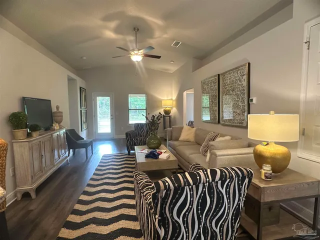 a bedroom with furniture and a flat screen tv