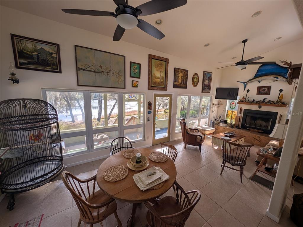 14730 Southeast 61st Street Road Ocklawaha, FL 32179 - Photo 16 of 88 a living room with furniture a flat screen tv and a fireplace