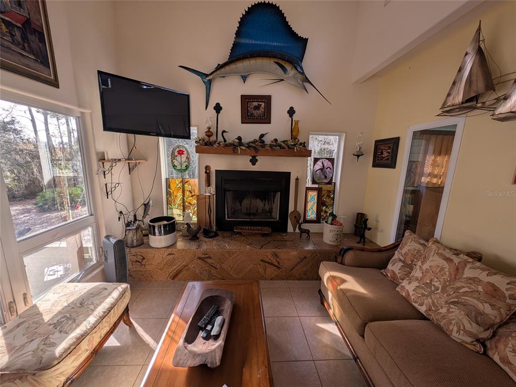 14730 Southeast 61st Street Road Ocklawaha, FL 32179 - Photo 19 of 88 a living room with furniture a flat screen tv and a fireplace
