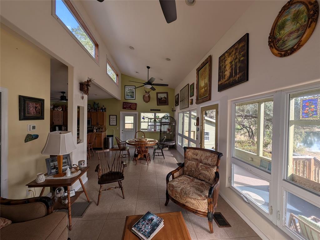 14730 Southeast 61st Street Road Ocklawaha, FL 32179 - Photo 22 of 88 a living room with furniture and a large window