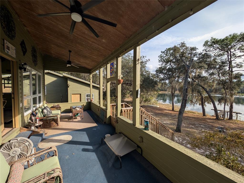 14730 Southeast 61st Street Road Ocklawaha, FL 32179 - Photo 27 of 88 a view of a porch with furniture and a yard