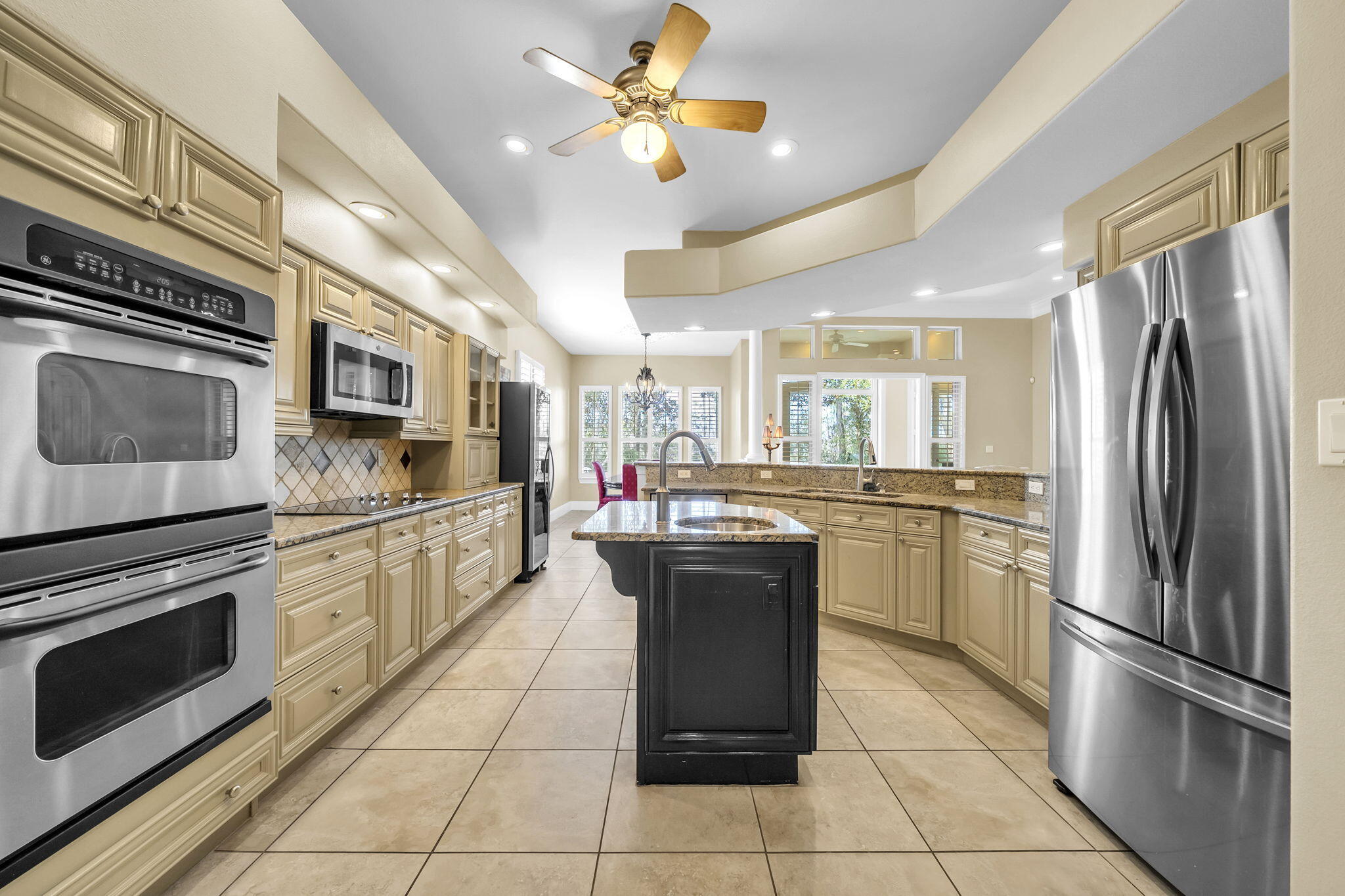 4595 Sailmaker Lane Destin, FL 32541 - Photo 16 of 50 a kitchen with stainless steel appliances granite countertop a stove cabinets and refrigerator