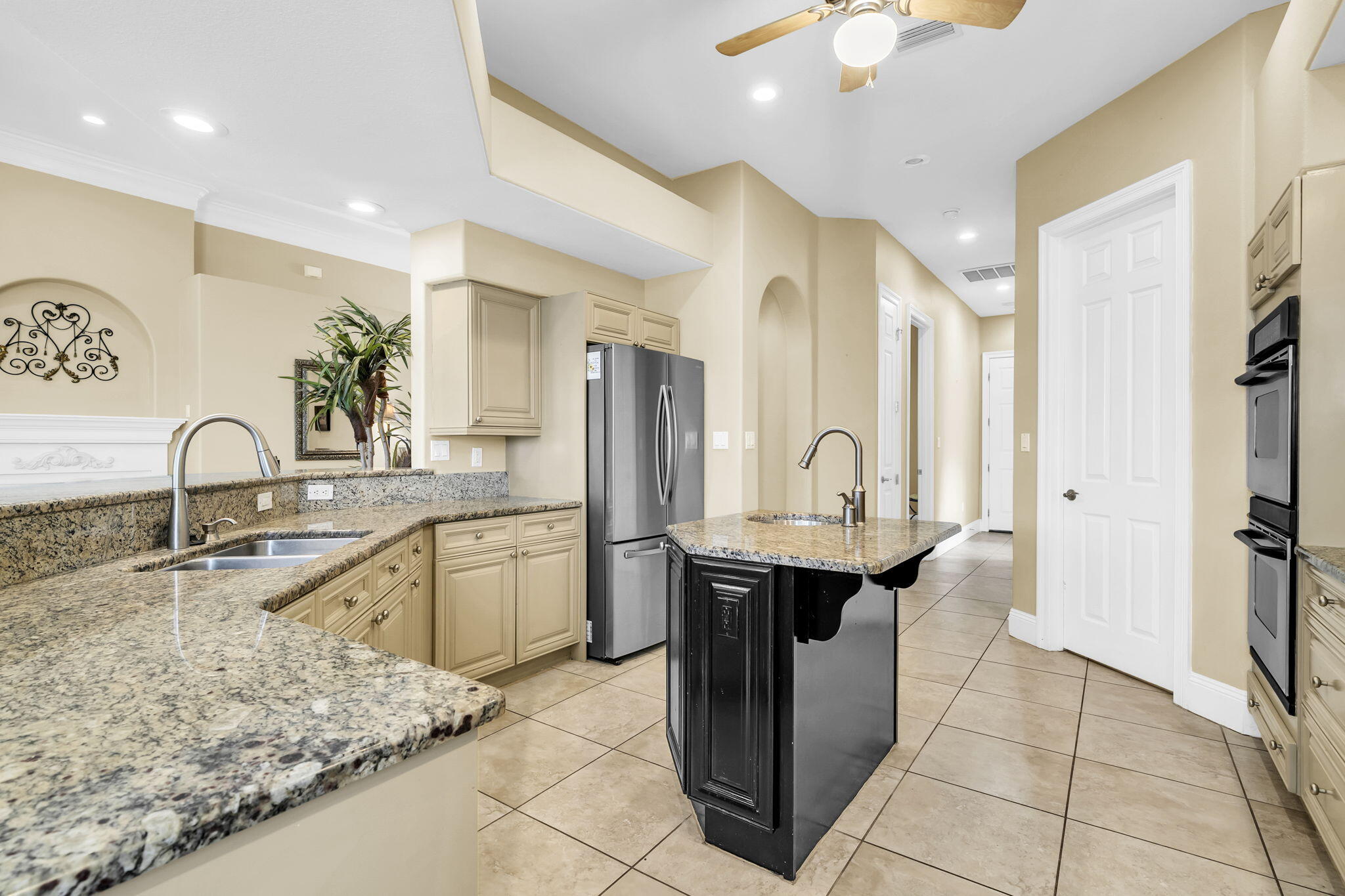 4595 Sailmaker Lane Destin, FL 32541 - Photo 17 of 50 a kitchen with stainless steel appliances granite countertop a sink and a refrigerator