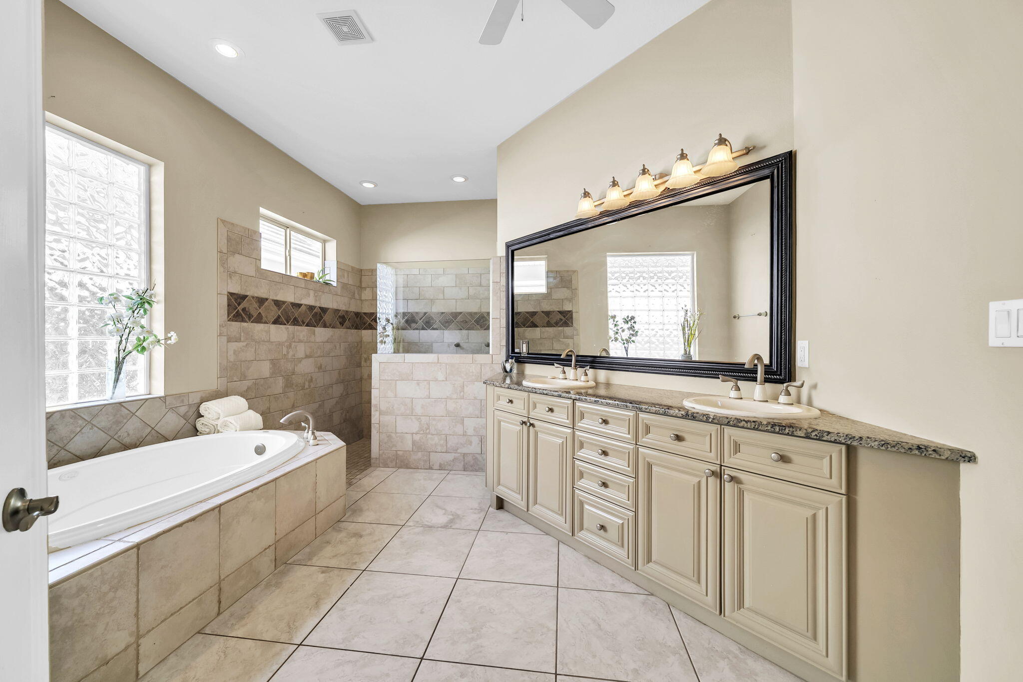4595 Sailmaker Lane Destin, FL 32541 - Photo 23 of 50 a bathroom with a sink vanity tub and mirror