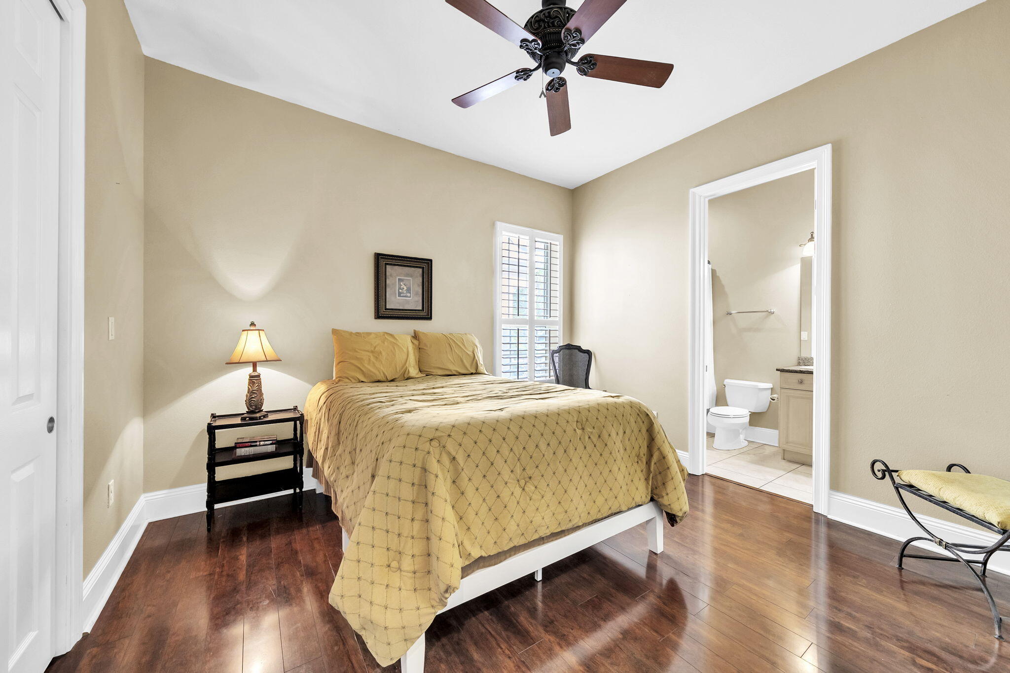 4595 Sailmaker Lane Destin, FL 32541 - Photo 30 of 50 a bedroom with a bed and wooden floor