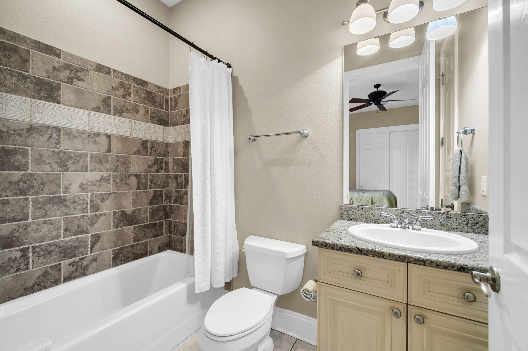 4595 Sailmaker Lane Destin, FL 32541 - Photo 36 of 50 a bathroom with a sink a toilet a mirror a bathtub and shower