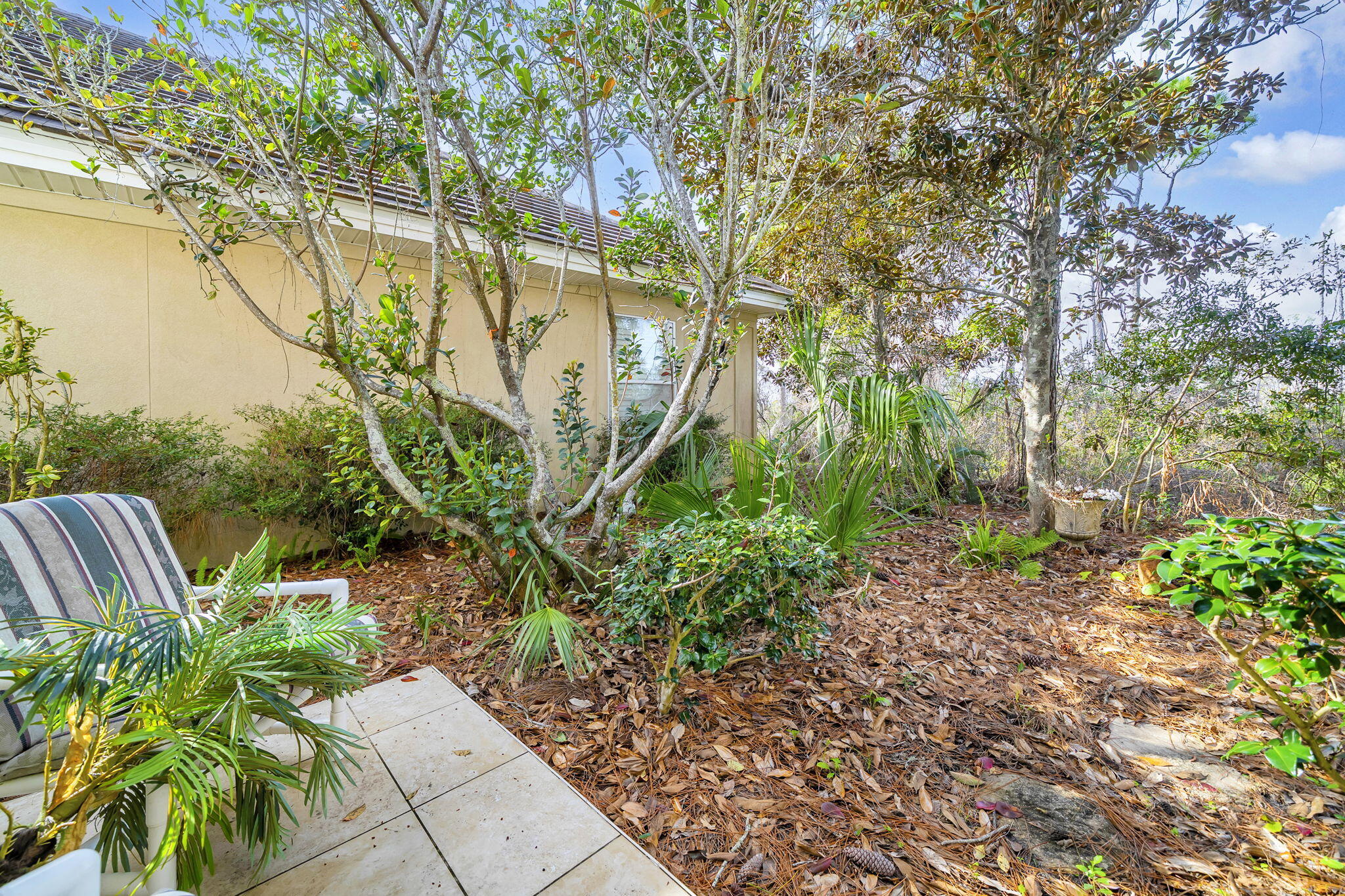 4595 Sailmaker Lane Destin, FL 32541 - Photo 41 of 50 a backyard of a house with lots of green space and fountain