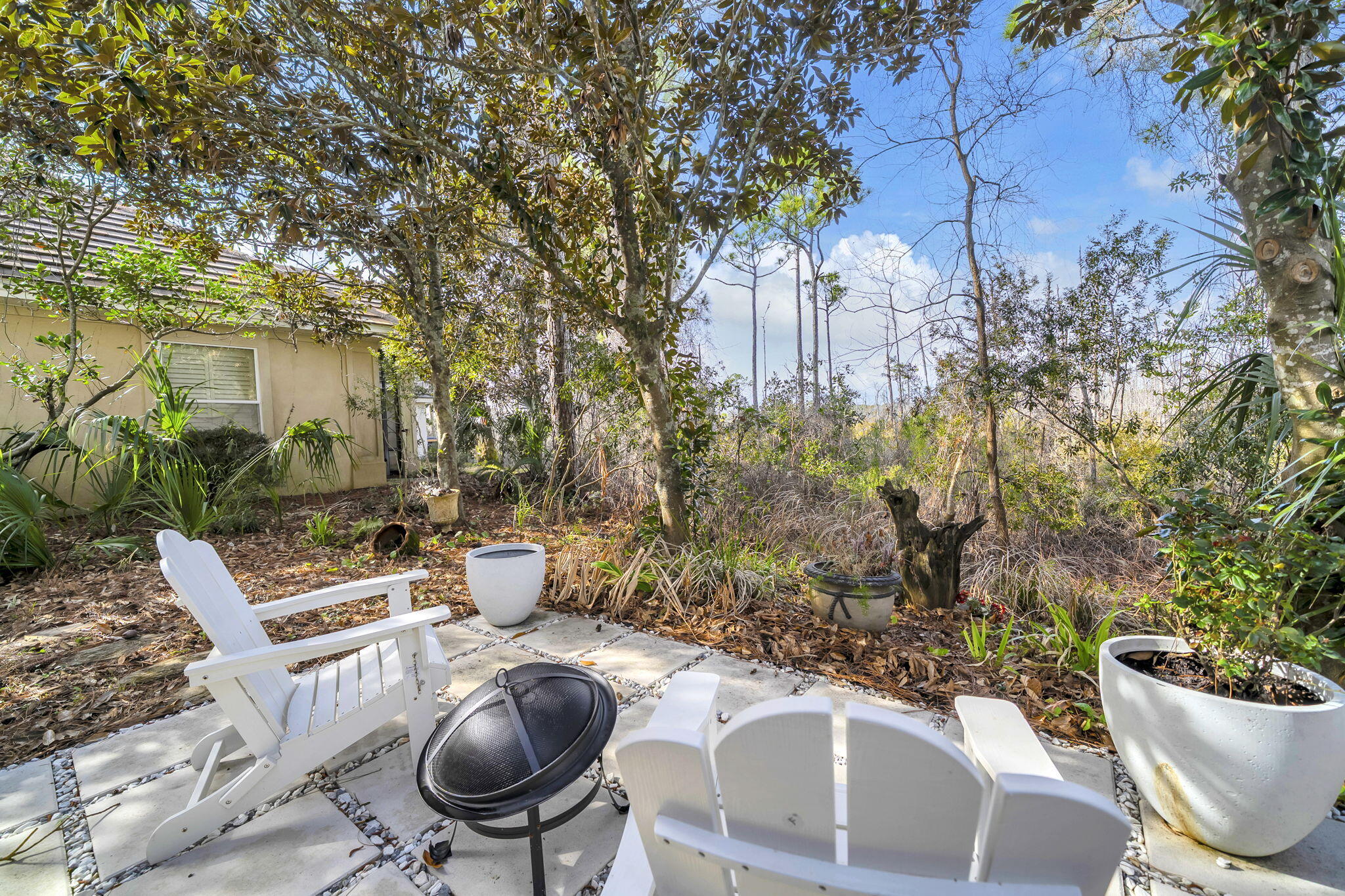 4595 Sailmaker Lane Destin, FL 32541 - Photo 46 of 50 a view of a chairs and table in backyard