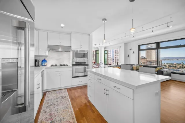a kitchen with white cabinets and appliances
