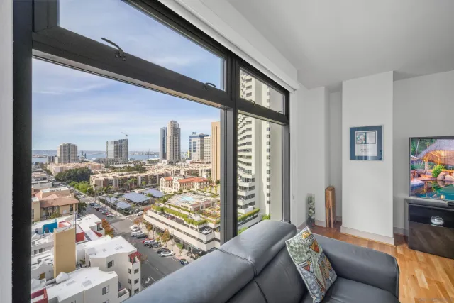 a living room with furniture and a floor to ceiling window