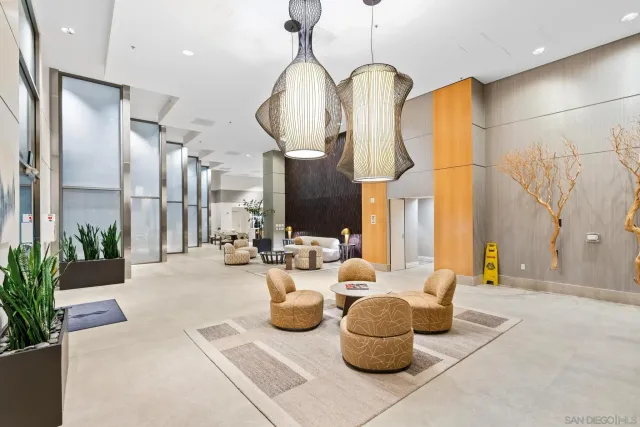 a lobby with furniture and potted plants